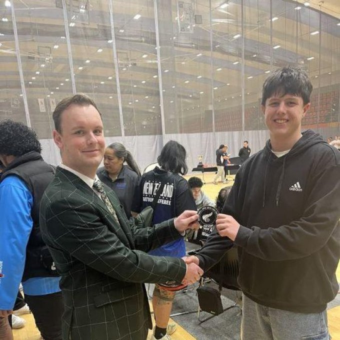 Noah Saunders (Year 12) gained his National Volleyball Referee Badge last week,  during the Volleyball New Zealand Club Nationals!

Due to an eye injury received at training a week before the tournament, Noah could not play with his club teammates at ACVC (Auckland Central Volleyball Club) who finished 9th in the Men’s 2nd Division.

Instead, Noah focused on supporting his team and obtaining his referee's badge, which involved theory and practical assessments.

Noah was rewarded for his hard work by 2nd refereeing one of the Men’s 1st Division Semifinals and 2nd refereeing the Women’s 1st Division Final.

Noah is pictured above receiving his badge from the tournament Referee Convenor.